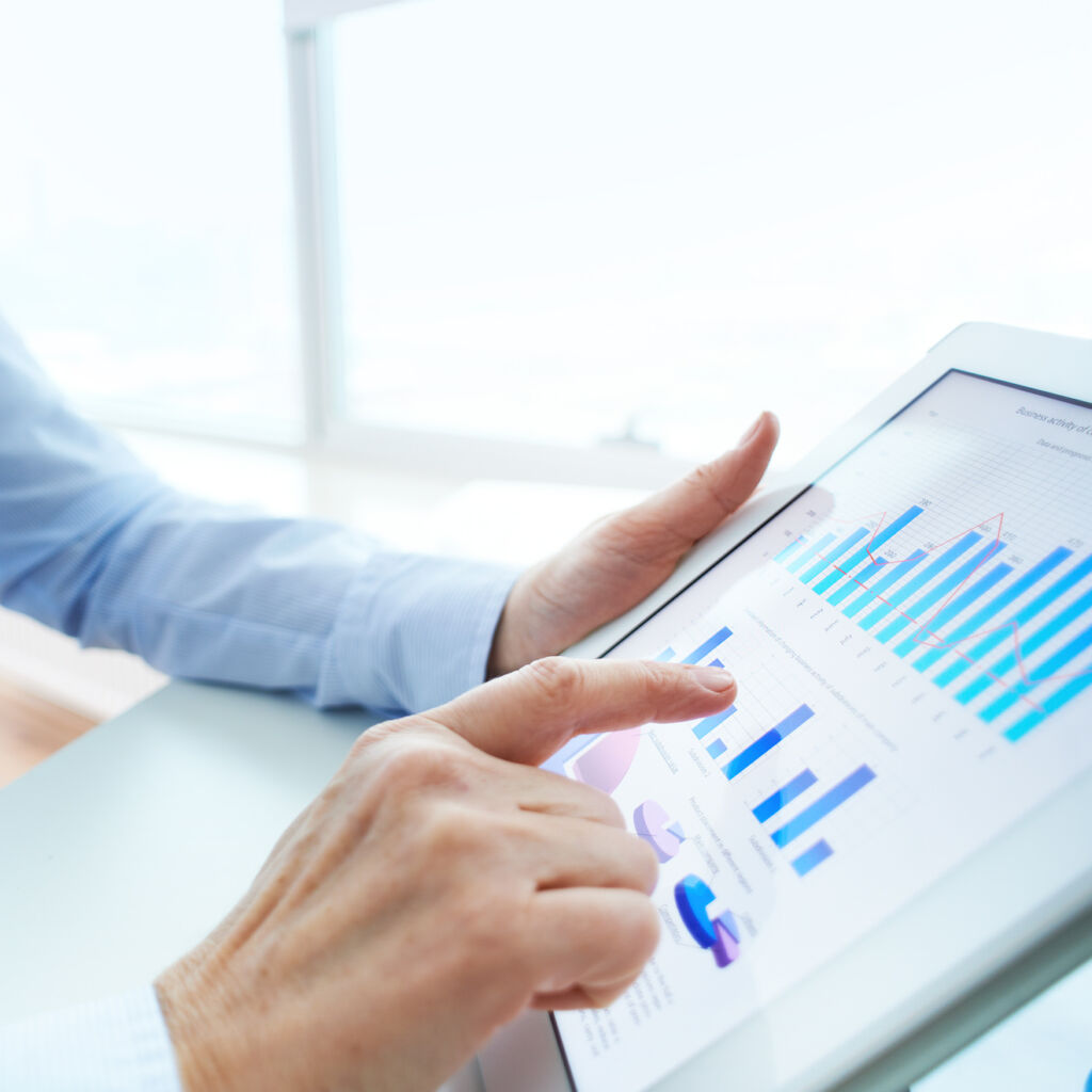 5 (Demo) online casino broker working on a tablet with graphs