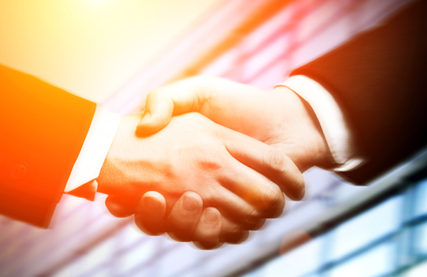 Business,Hand,Shake,And,A,Office,In,Background Close-up of adult industry professionals shaking hands